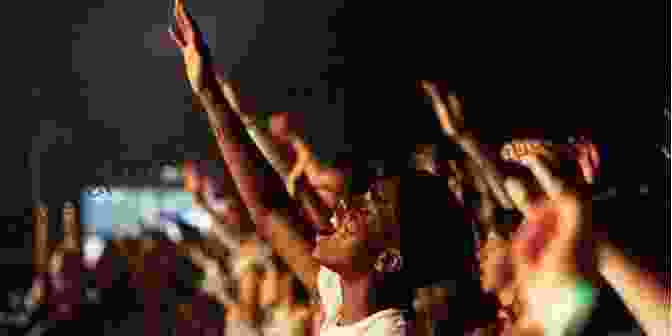 A Group Of Worshipers Raising Their Hands In Praise Worship Wars: What The Bible Says About Worship Music